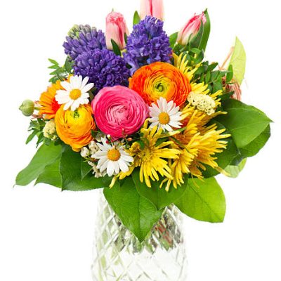 beautiful bouquet of colorful spring flowers in a glass vase. tulip, ranunculus, hyacinth, daisy, gerber